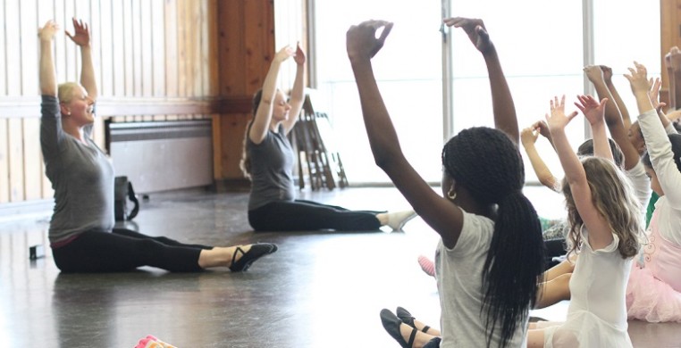 Synapse Arts ballet class at Loyola Park: dance teachers lead students through a stretch on the floor