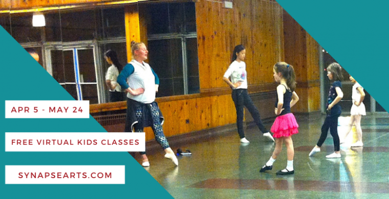 Young dancers in a wood paneled studio space face a mirror while a teacher and assistant demonstrate at the front.