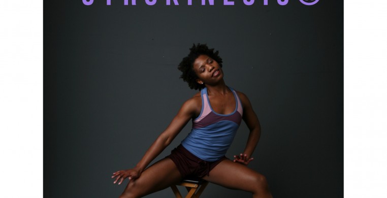 Jamila seated on a stool  torso bending to side with legs wide on a gray background. In lilac font above reads OPEN GYROKINESIS