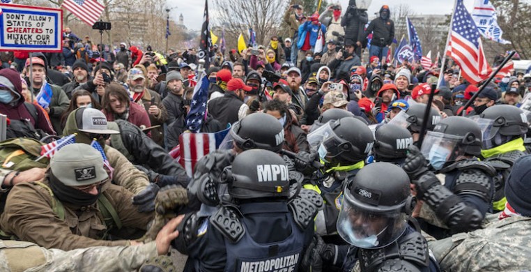 A mob of Trump supporters pushing against police forces on Jan. 6 at the U.S. Capitol. Photo by Blink O'fanaye on Flickr, via Creative Commons.