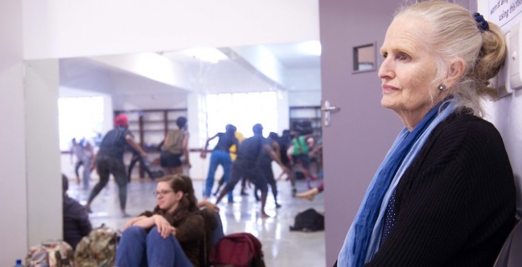 SCD editor Lauren Warnecke (background) watching a master class led by Moving into Dance Mophatong with Adrienne Sichel in Durban, South Africa (2018). Photo by Val Adamson.