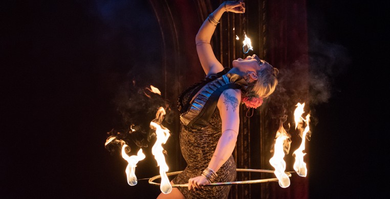 Raks Inferno: Dancer in a fire hoop eating fire.